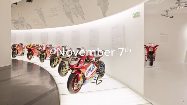 Dramatic reveal moment of a new motorcycle under spotlights at a major show