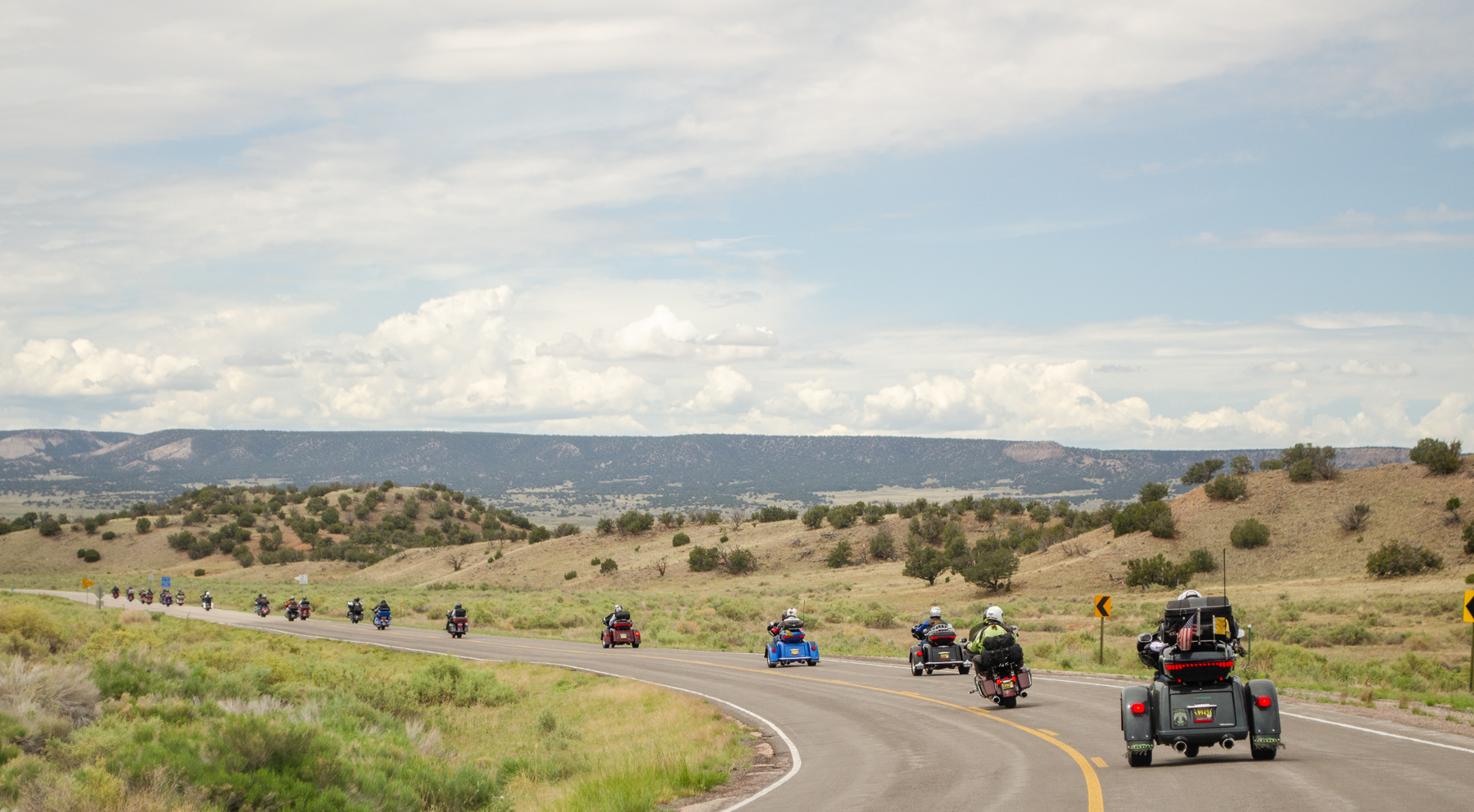 Motorcycle on the Turquoise Trail with Sandia Mountains in background
