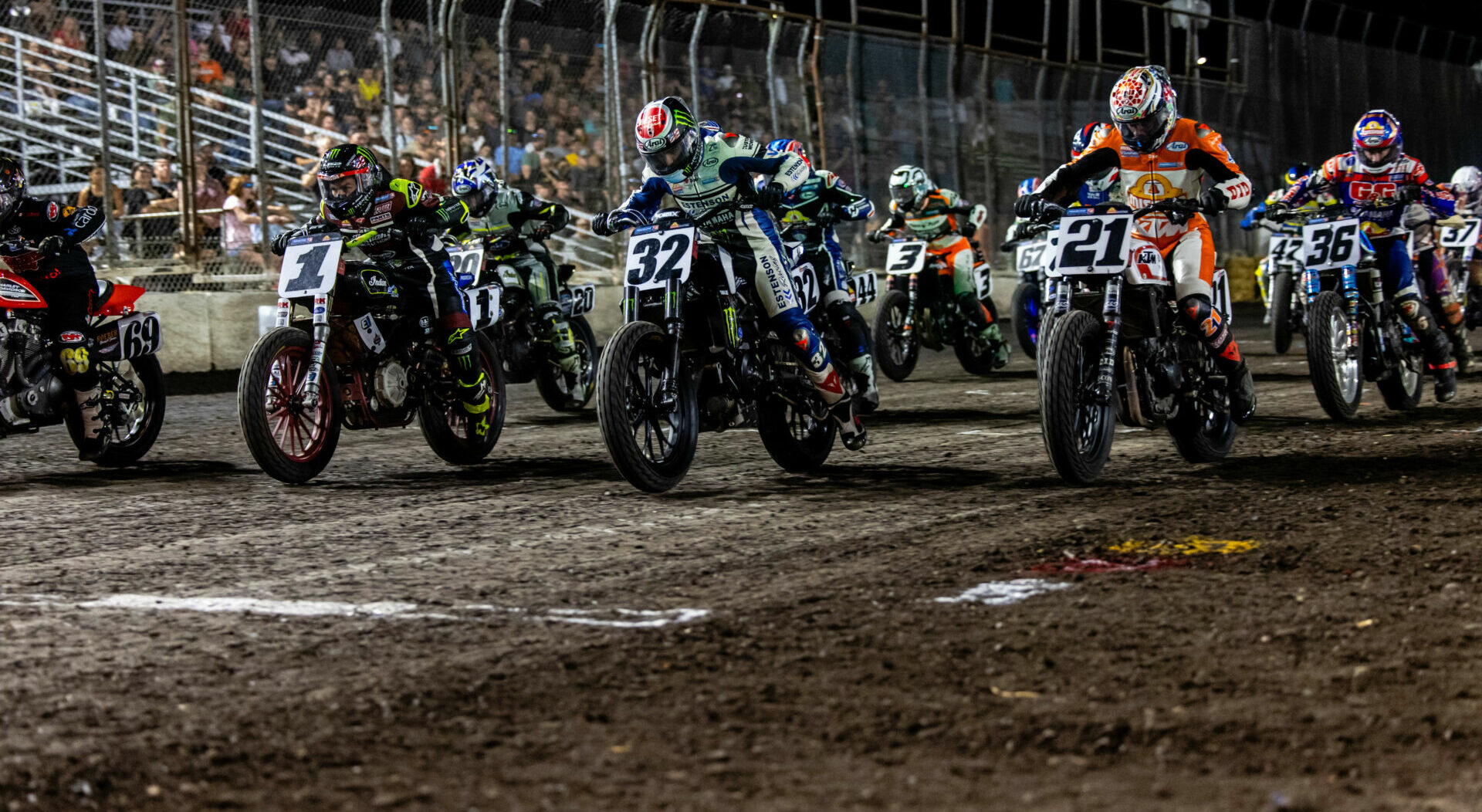 Race start or pack of flat track riders on dirt oval