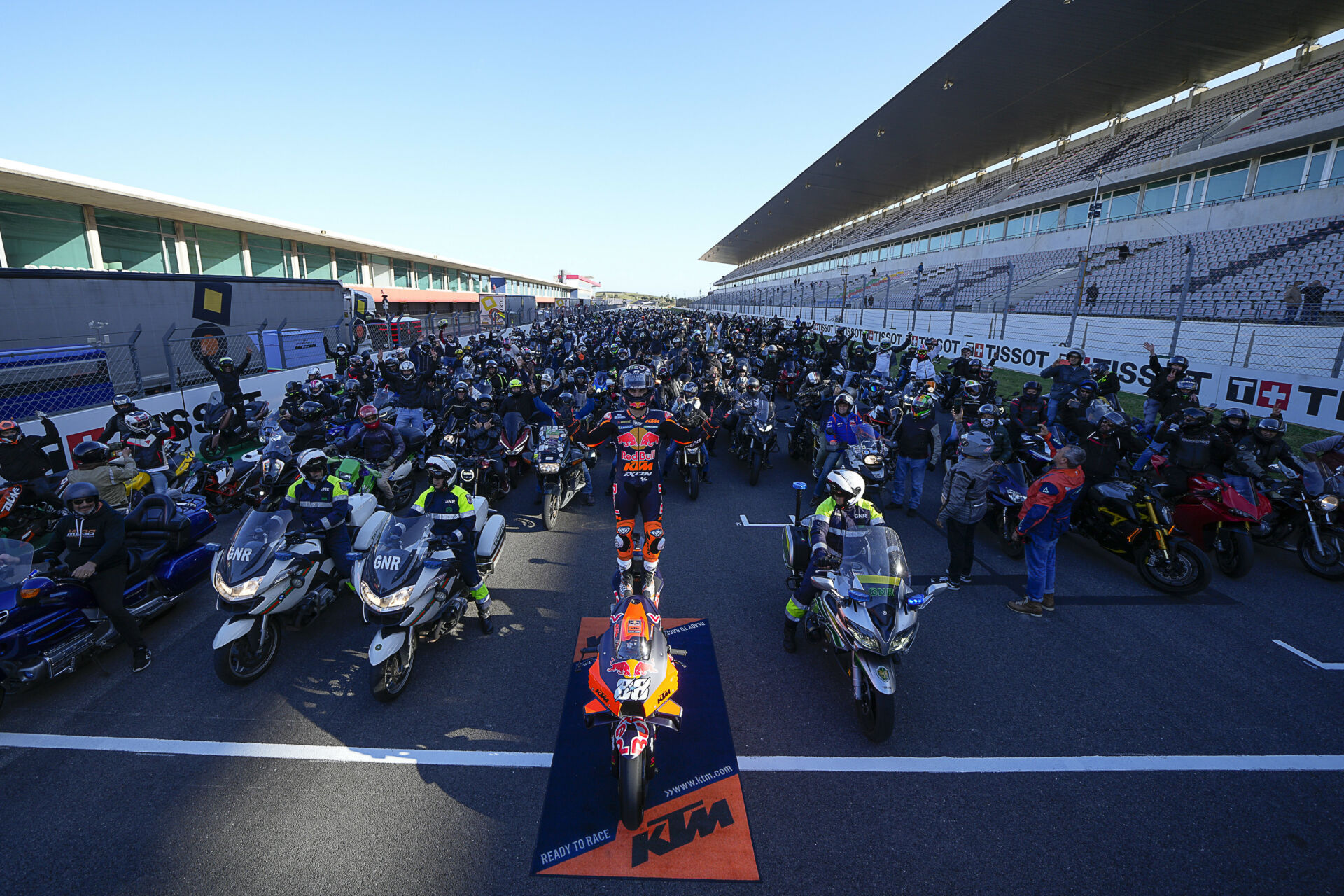 Race fans watching from grandstands at motorcycle road racing event