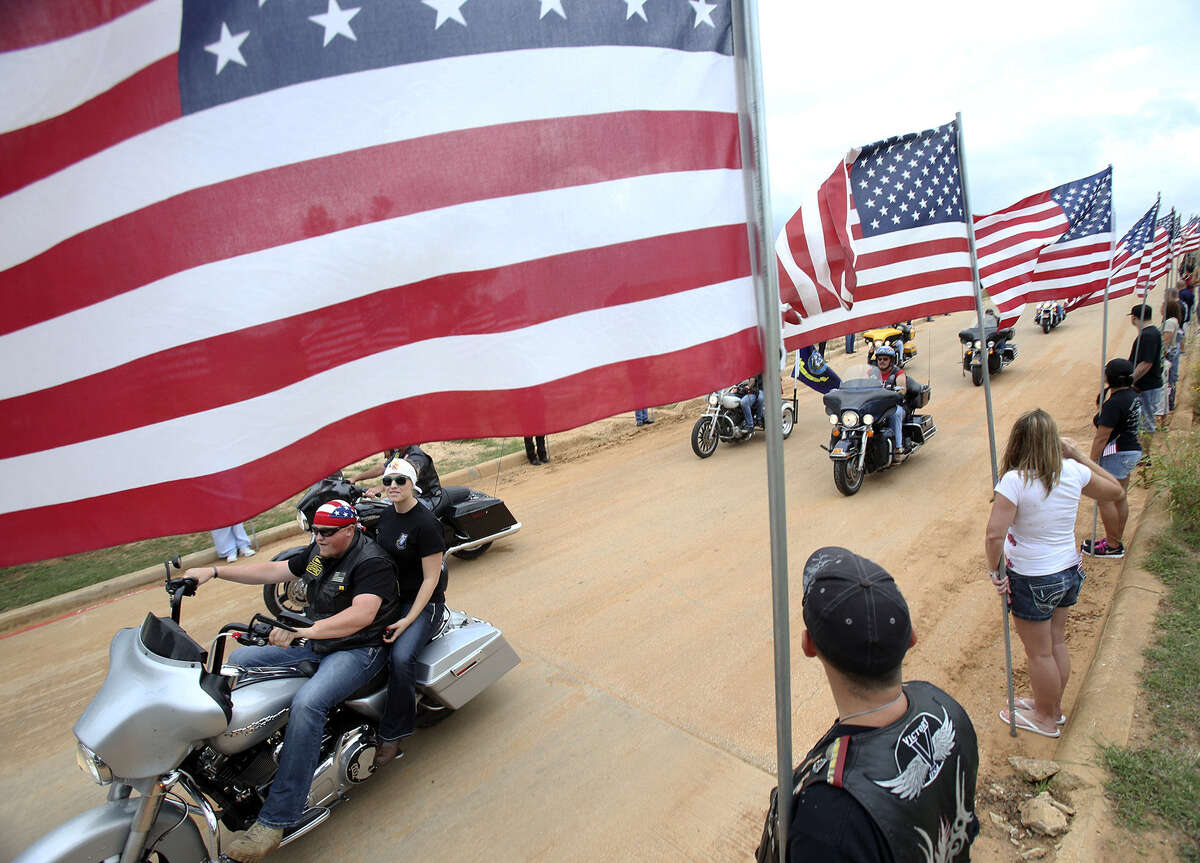 Riders with American flags or veterans imagery representing the cause