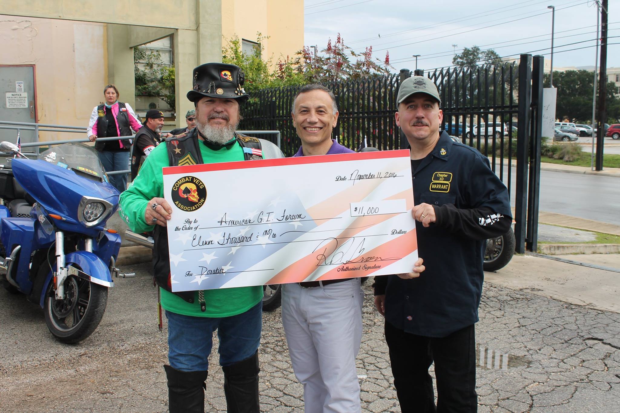 Representatives presenting fundraising proceeds to a veterans organization