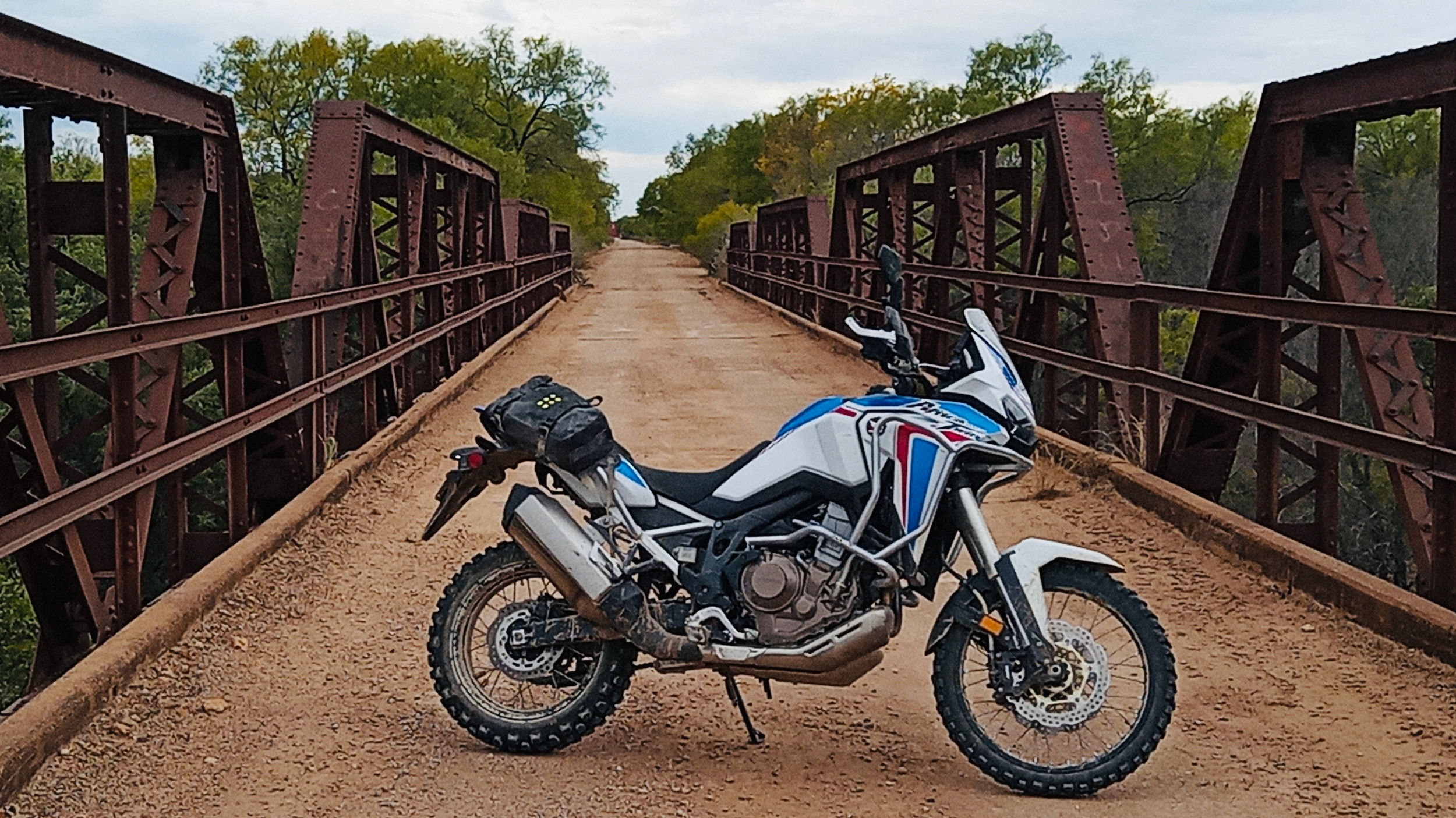 ADV or dual sport rider on a Texas back road in fall