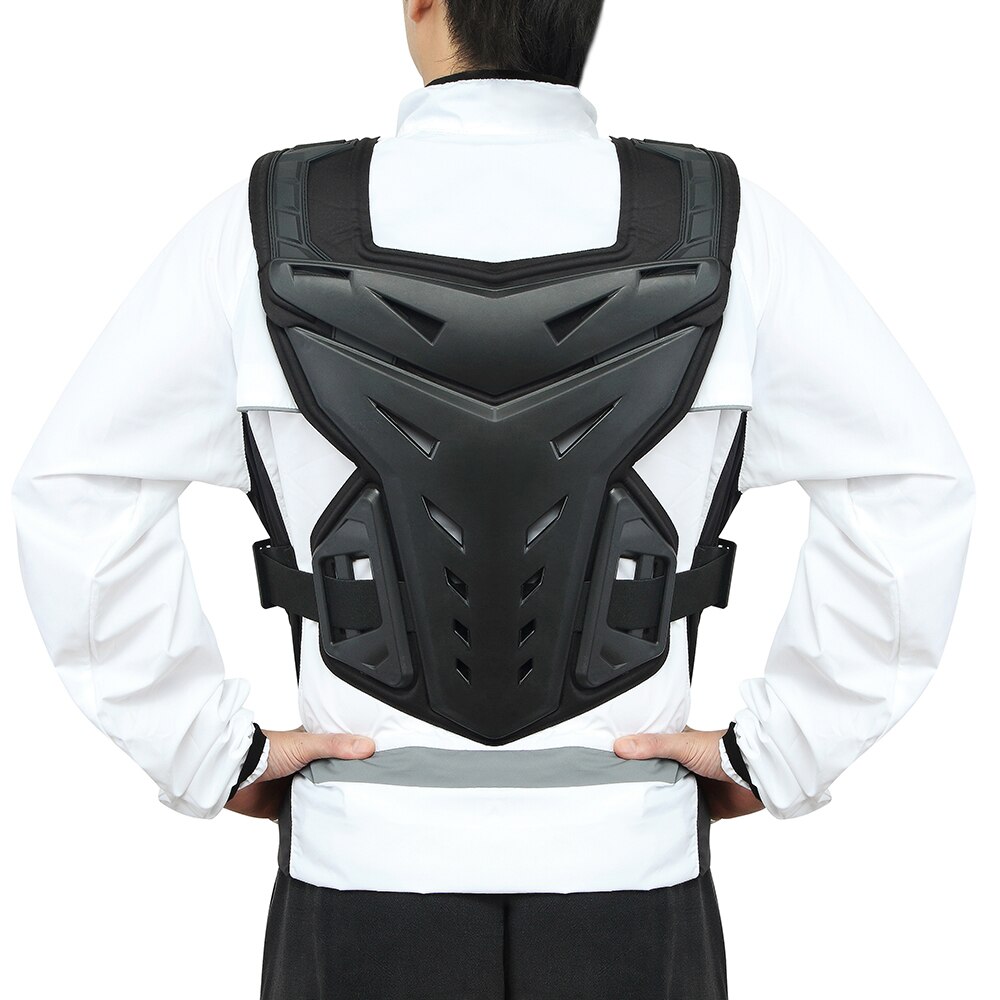 Adventure rider wearing chest and body armor on gravel trail