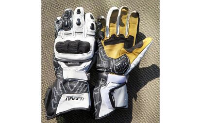 Adventure rider wearing gloves on a gravel or dirt road