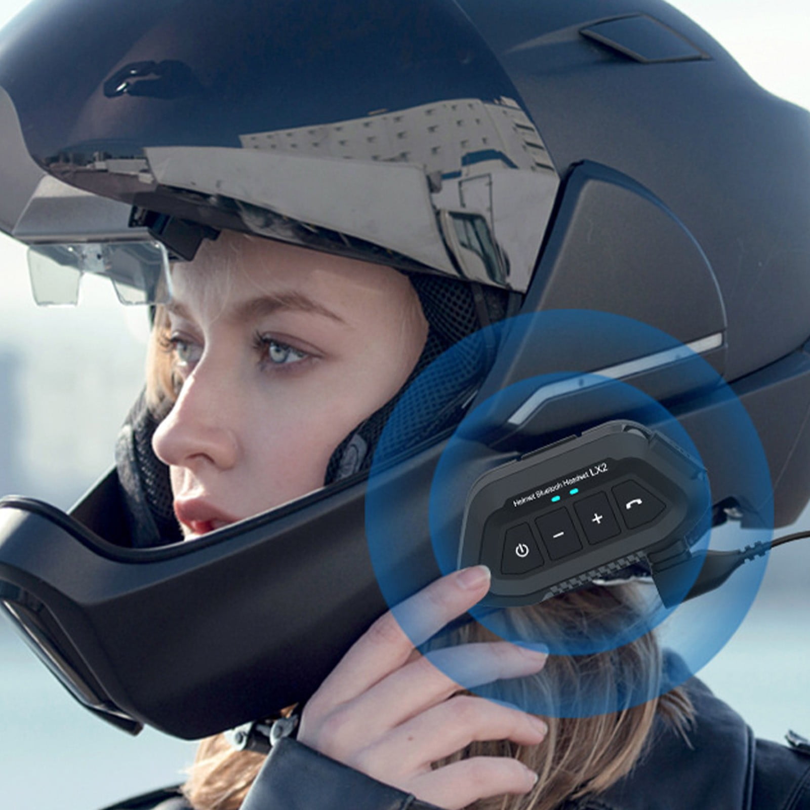 Close-up of a Bluetooth intercom unit mounted on a full-face helmet