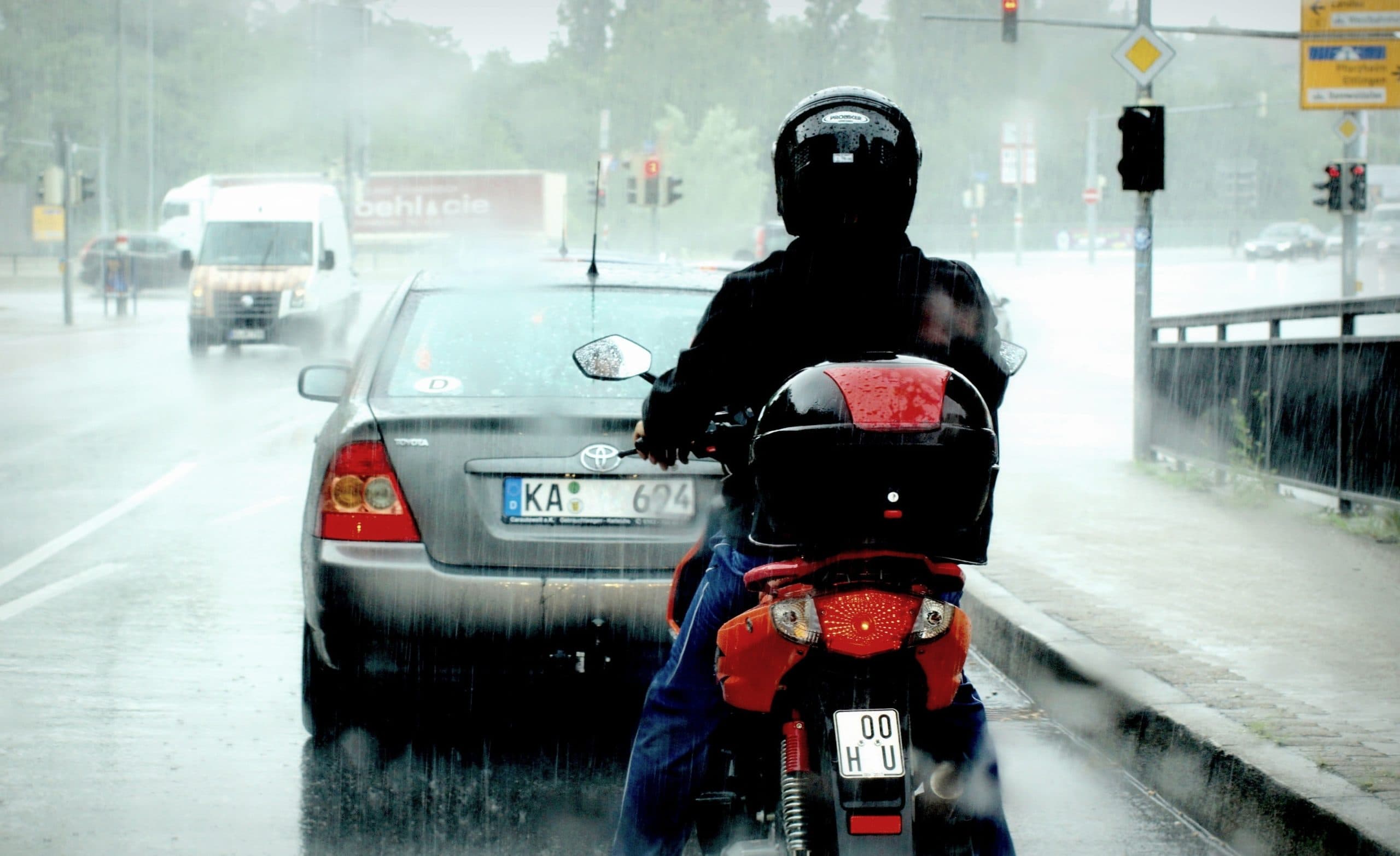 Urban commuter rider in rain gear for commuter section