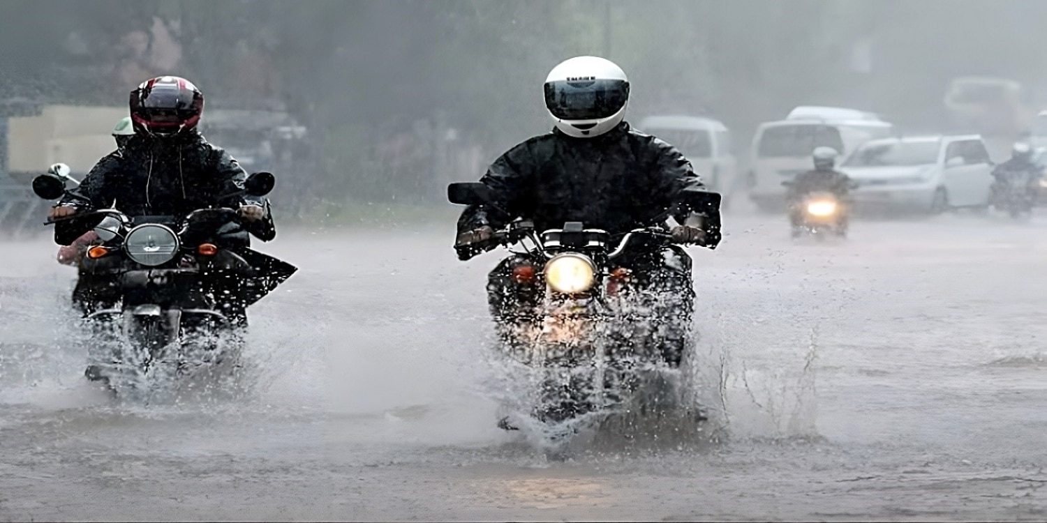 Hero image showing motorcycle being ridden on wet roads in rainy conditions