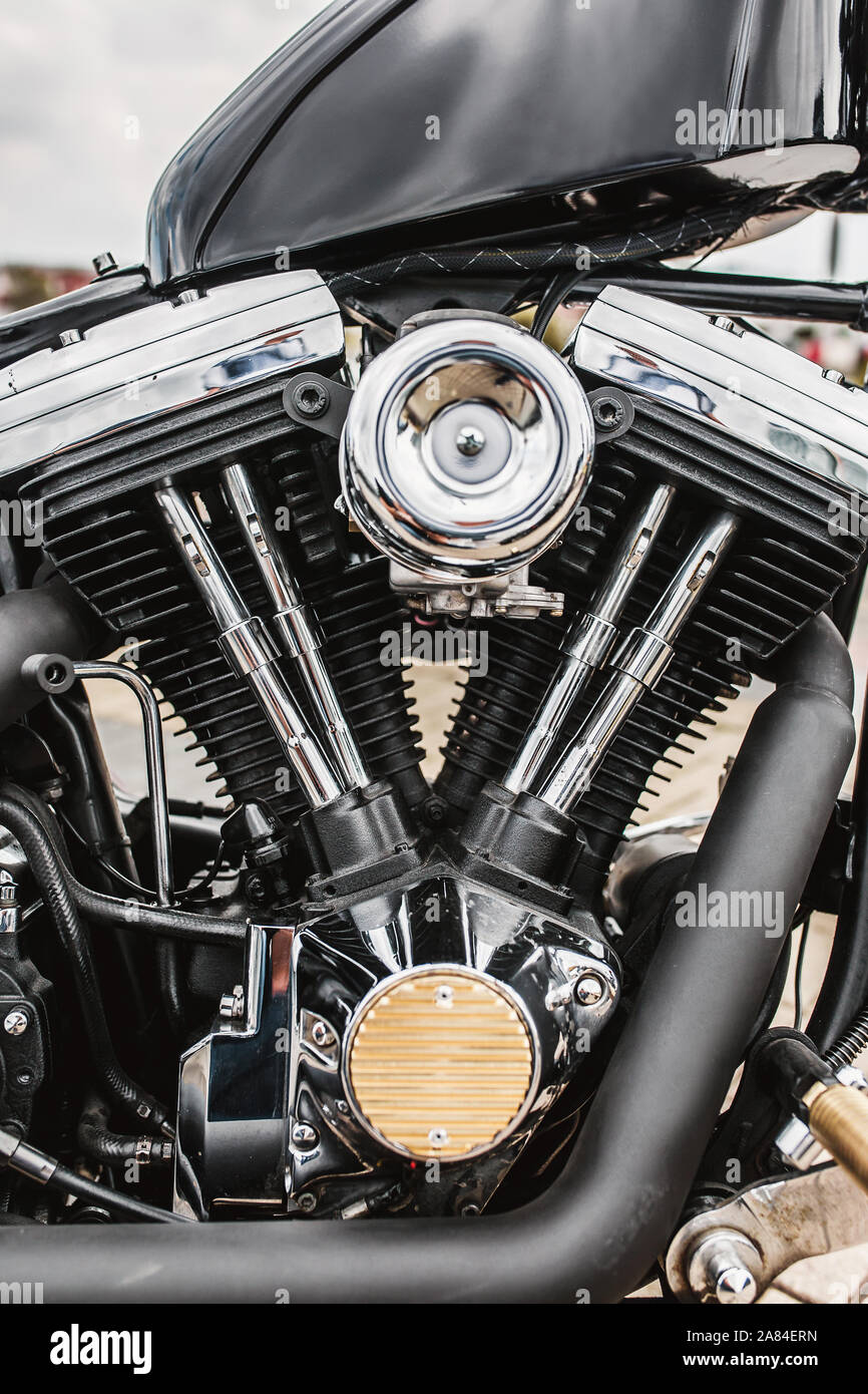 Close-up of a classic motorcycle carburetor showing jets and float bowl