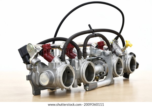 Close-up of a modern motorcycle fuel injection throttle body and injectors