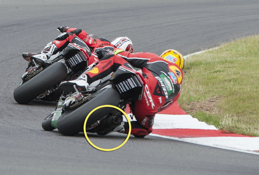 Action shot of a sportbike rider leaning through a corner at a track day
