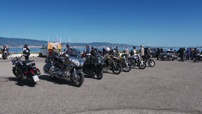 Wide shot of motorcycles gathered at a rally or chapter meetup