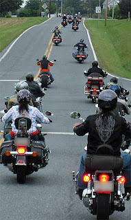 Road captain leading a group ride in formation on an open road