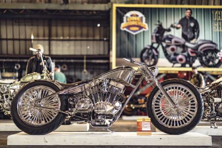 Custom motorcycle at an outdoor show event representing post-ride gathering