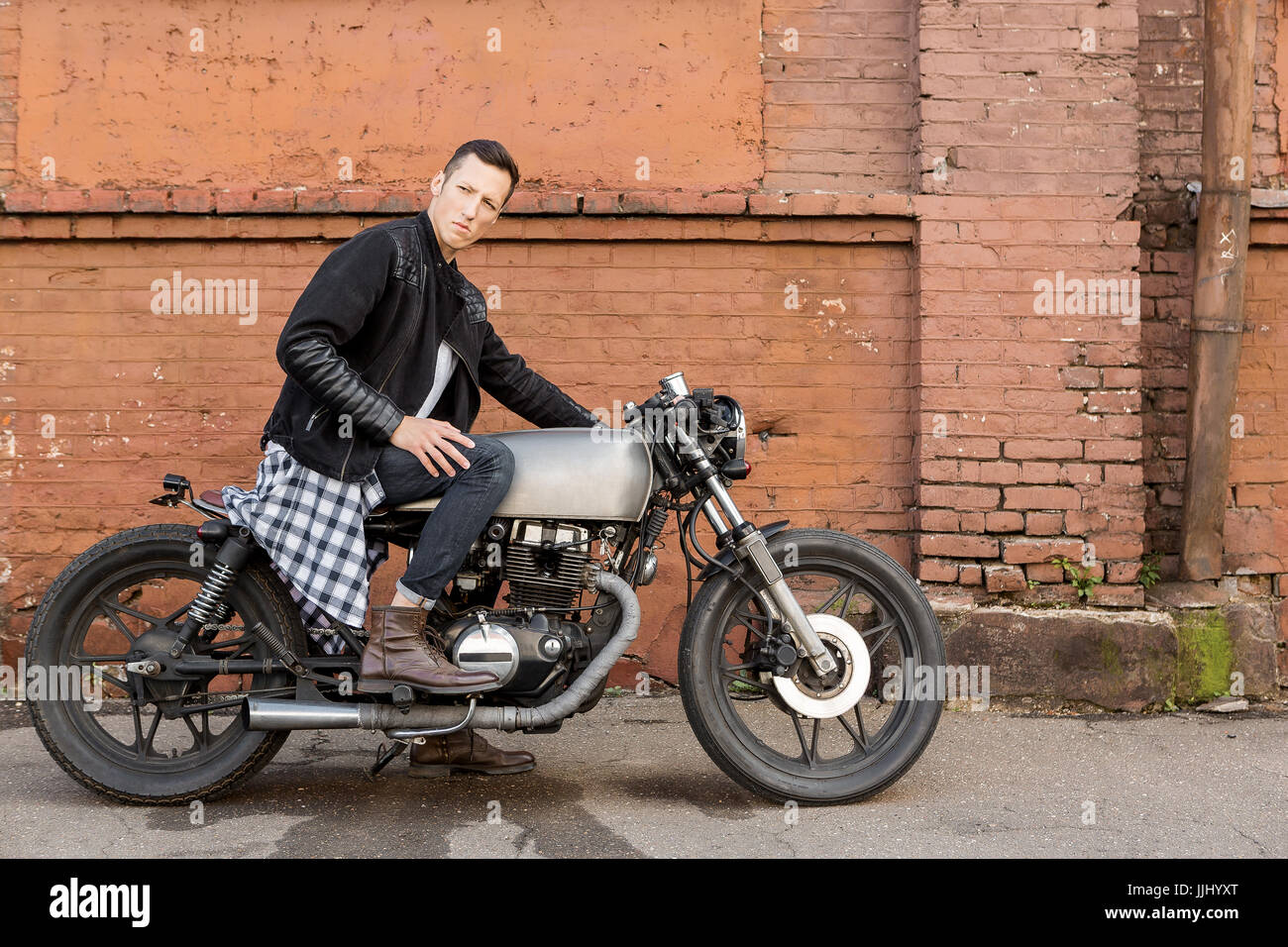 Stylishly dressed rider on a classic or retro-style motorcycle
