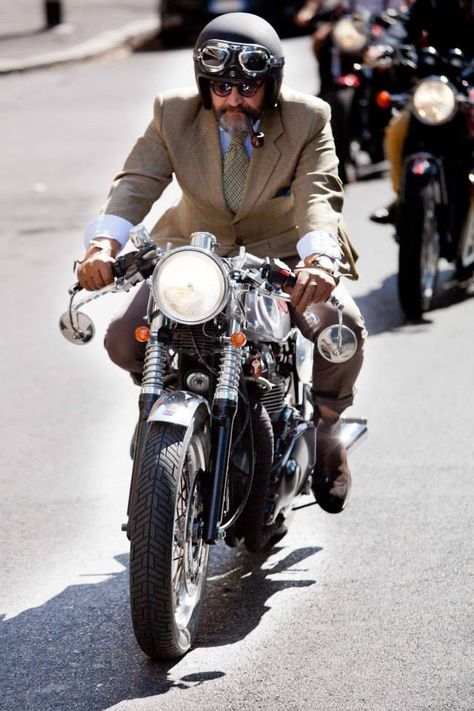 Dapper rider on a classic or vintage motorcycle illustrating DGR style