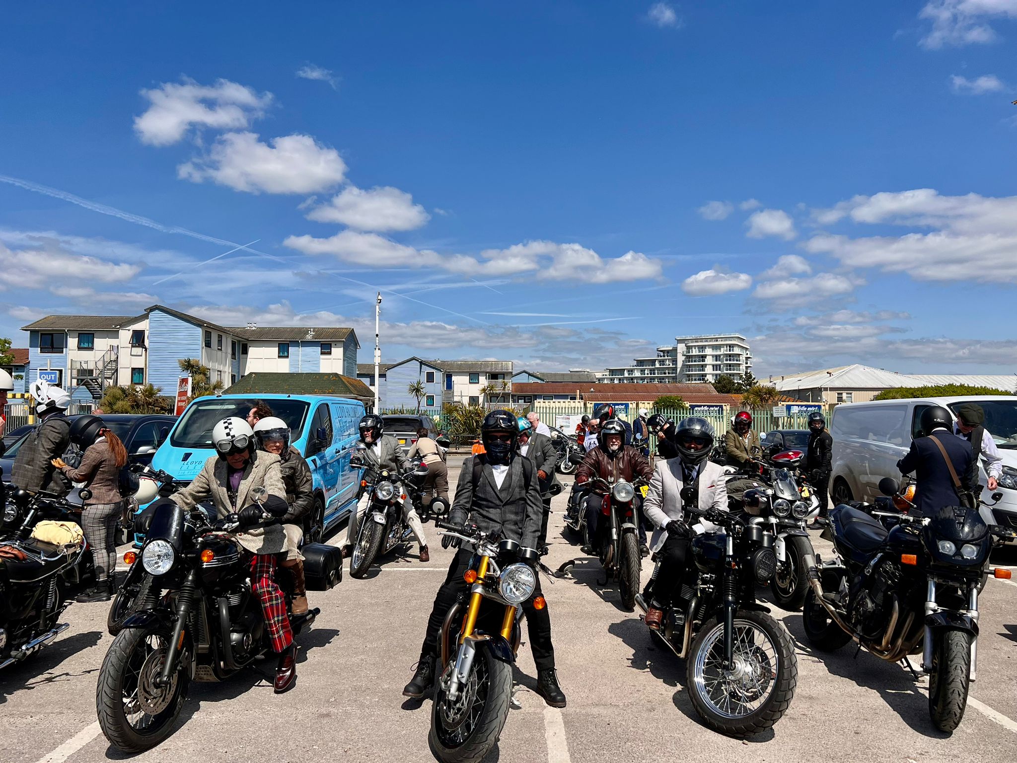 Staging area scene with riders gathering before group ride departure