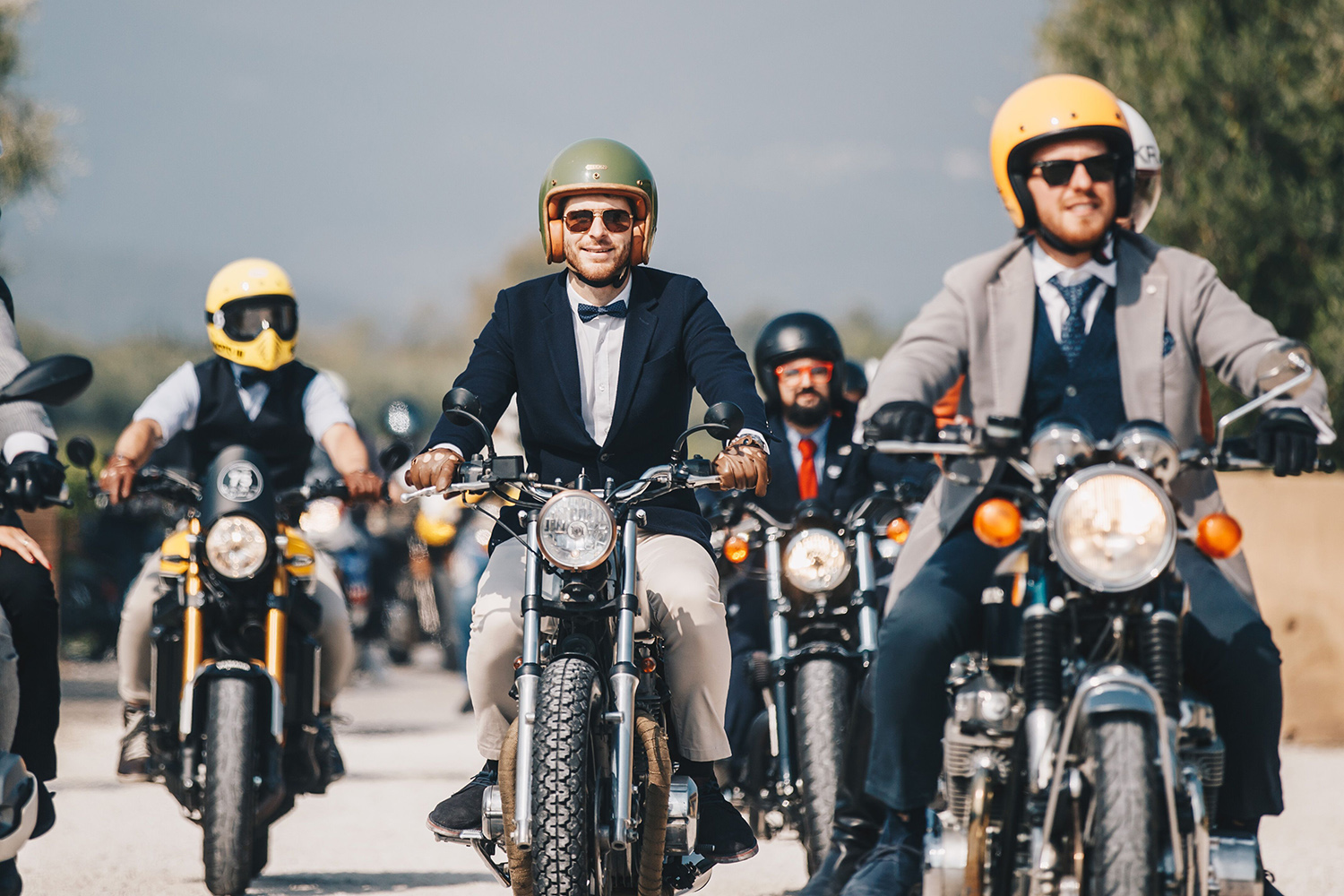 Close-up of a dapper rider on a vintage or classic motorcycle illustrating the DGR dress code
