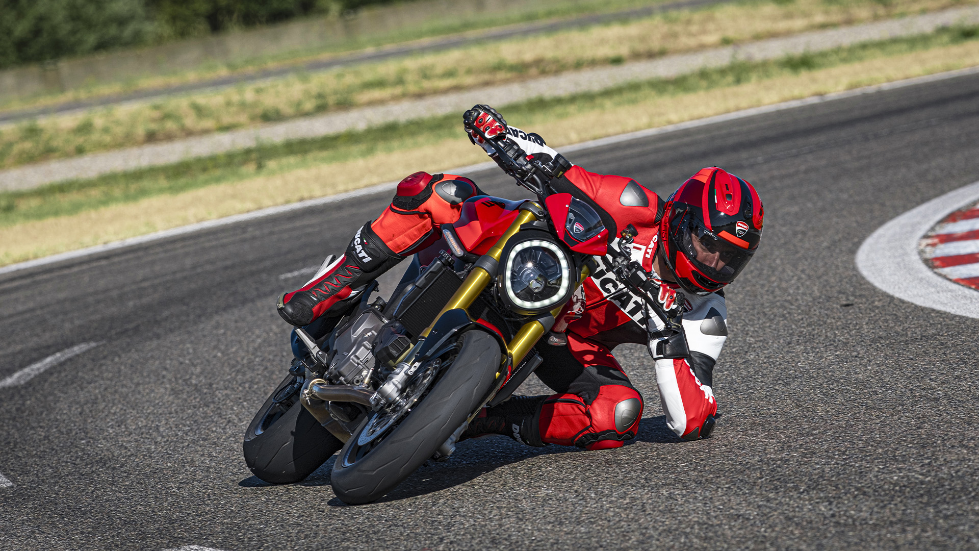 Rider on Ducati Monster SP on a twisty road for the ergonomics and styling section