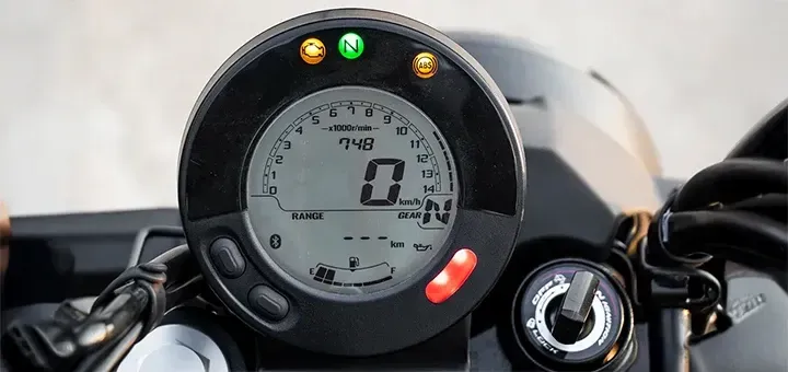 Close-up of the minimalist digital instrument cluster and handlebar controls