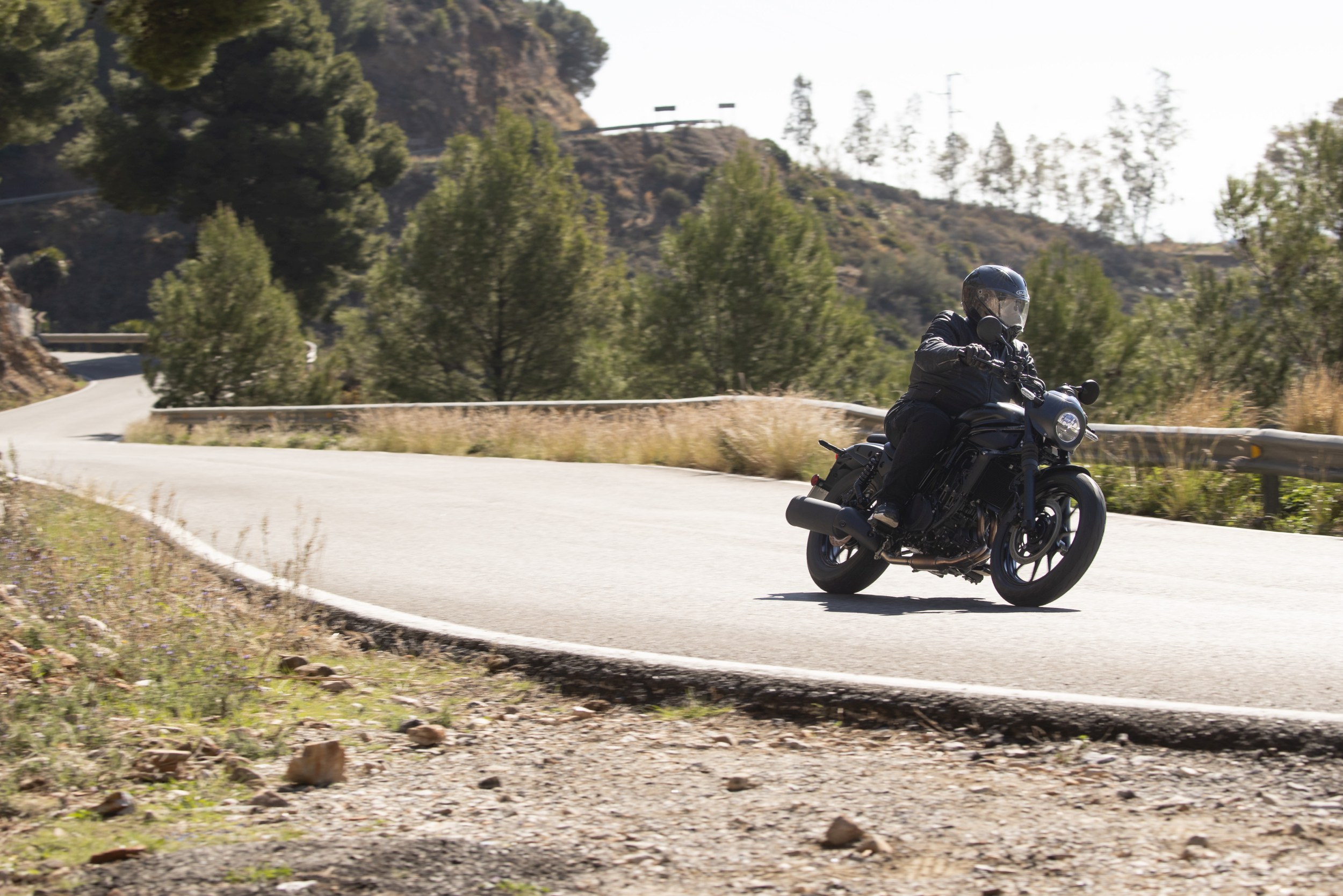 Action shot on an open highway illustrating long-distance riding posture and confidence
