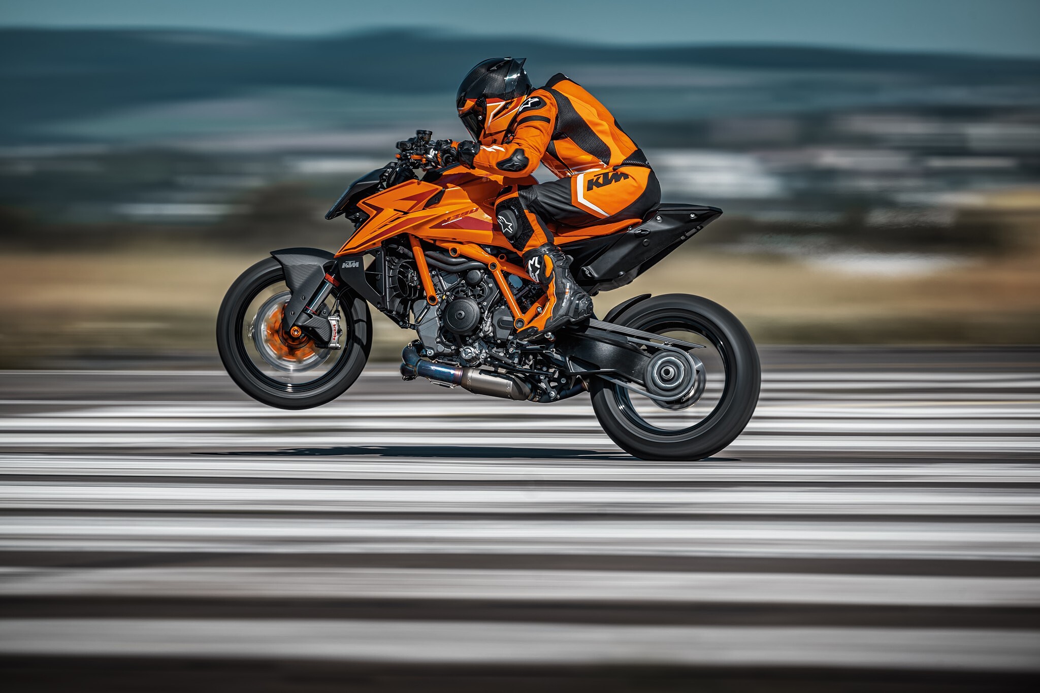 Hero image — dramatic action shot of the 2026 KTM 1390 Super Duke R Evo on a mountain road