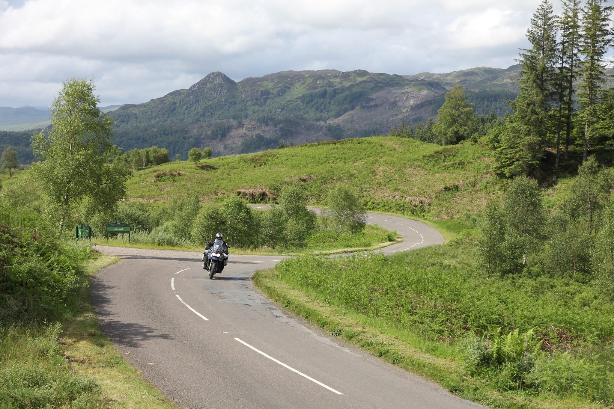 Atmospheric landscape shot of adventure bike on Highland or Welsh mountain road