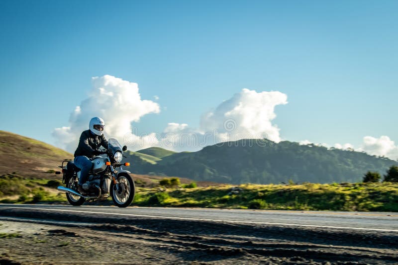 Action shot of a rider on an adventure bike on a winding road for the verdict section