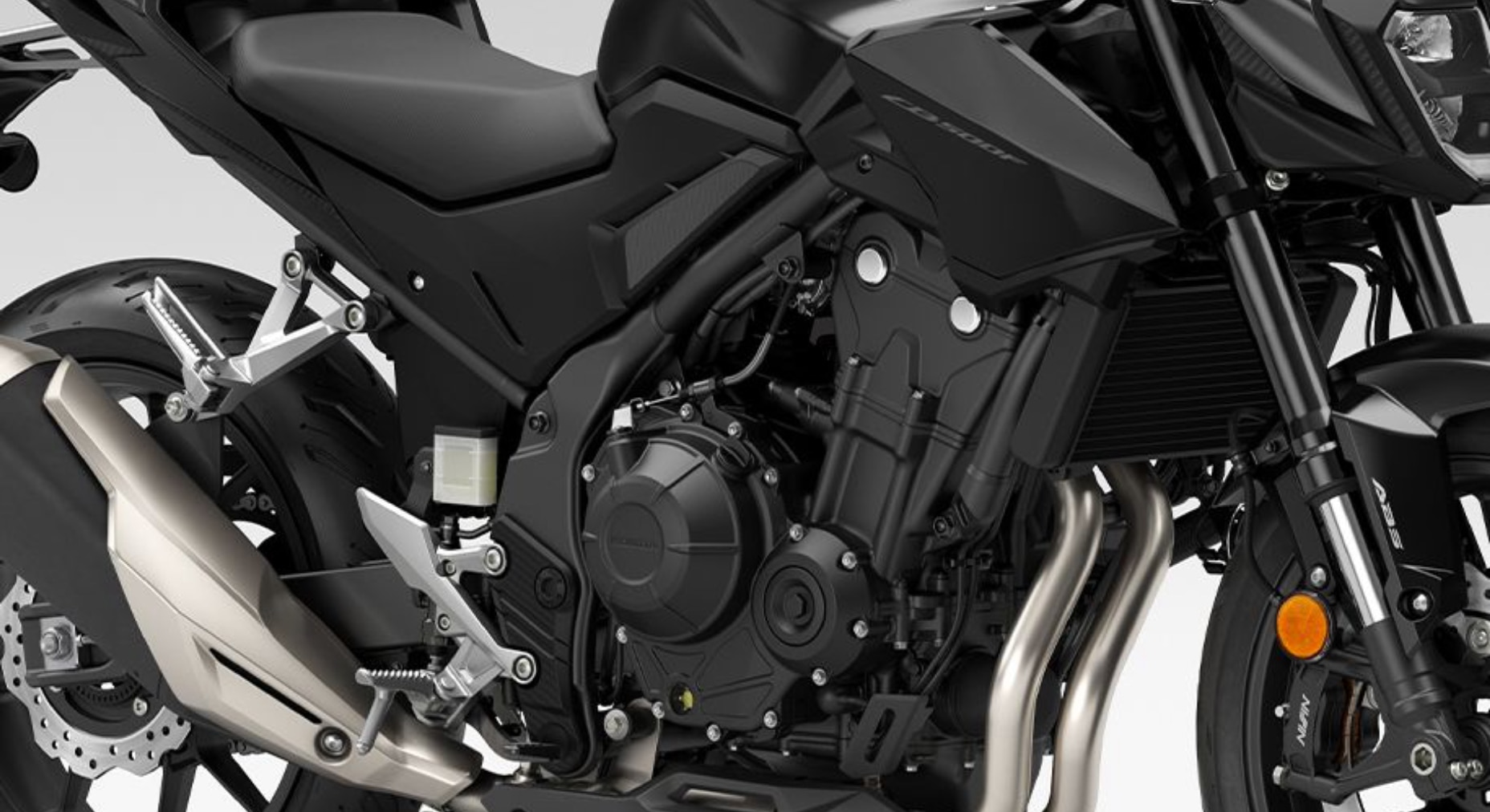 Close-up of the shared 471cc parallel-twin engine