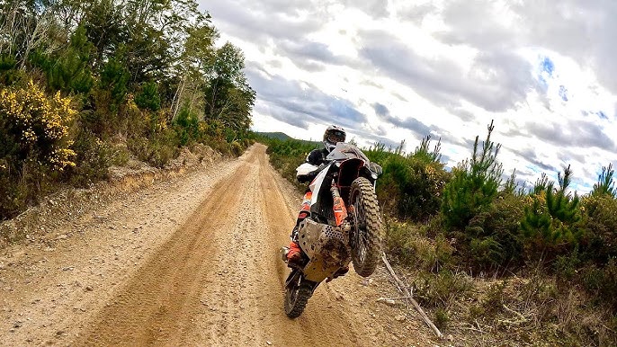 Mid-range KTM adventure bike on off-road terrain for mid-range section