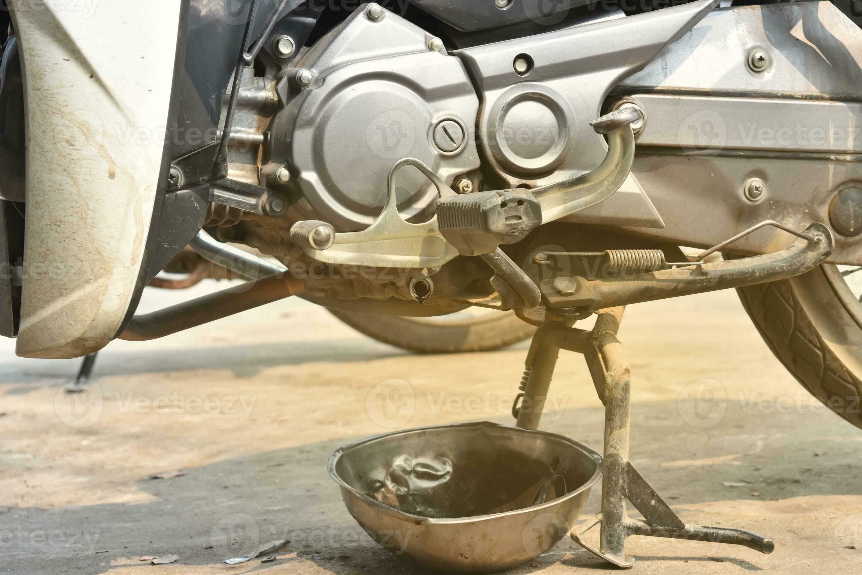 Close-up of engine oil being checked or changed on a motorcycle