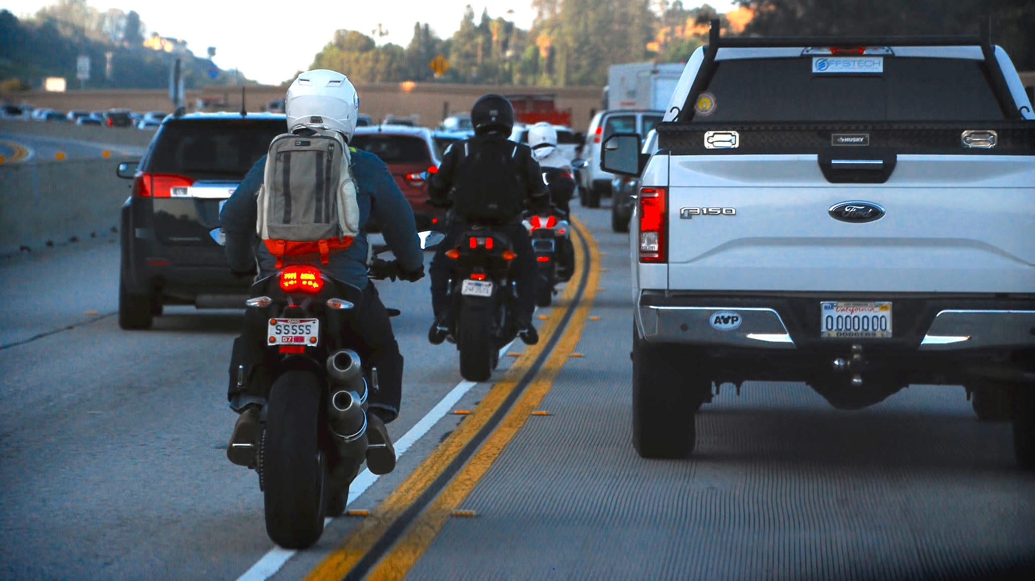 Illustrative image of lane filtering or splitting concept on a busy freeway