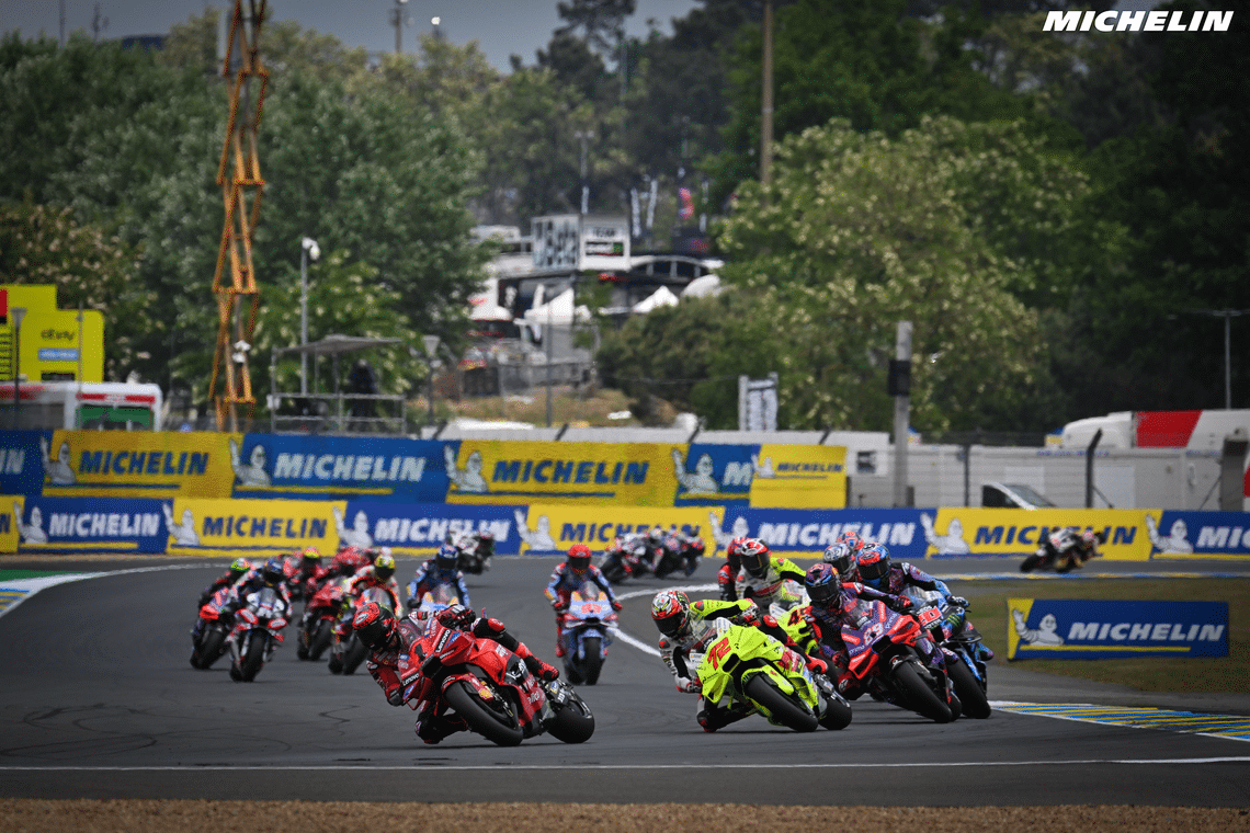 Close racing and overtaking moment at a tight hairpin corner