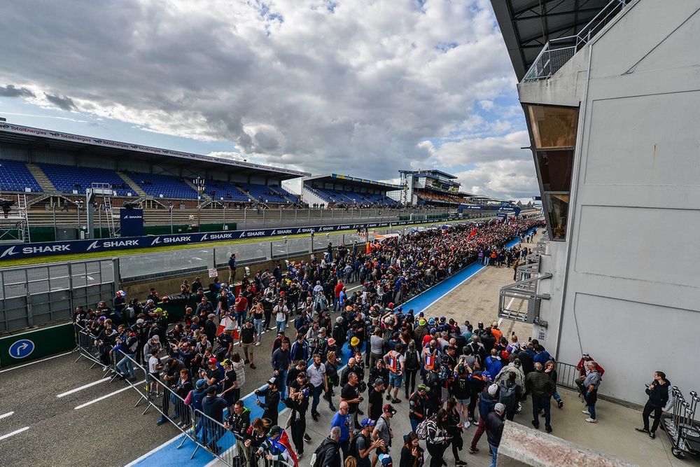 Enthusiastic fan crowd in grandstands at a MotoGP event