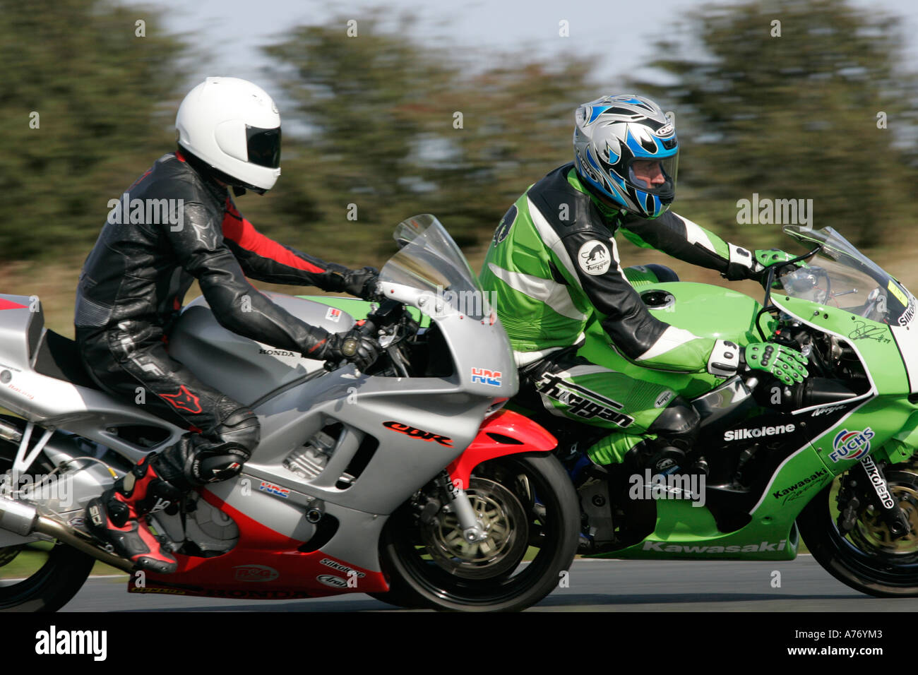 Rider suiting up or inspecting gear in paddock