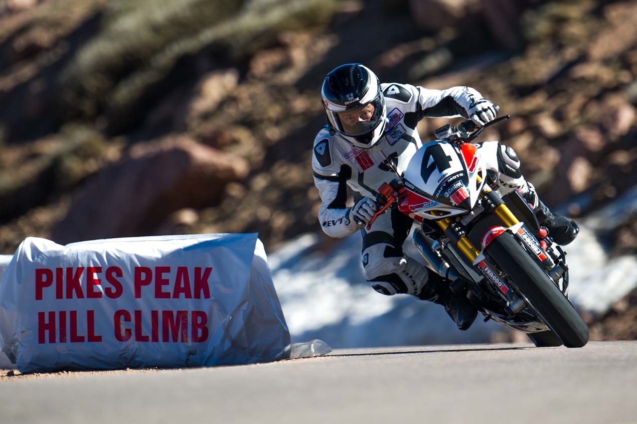Hero image showing a motorcycle competitor on the Pikes Peak course with mountain backdrop