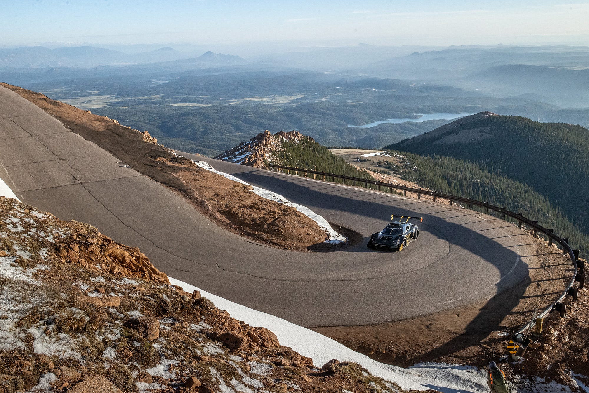 Aerial or wide shot showing switchbacks and dramatic elevation on the course
