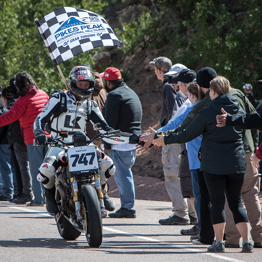Paddock scene showing motorcycle teams preparing for race day
