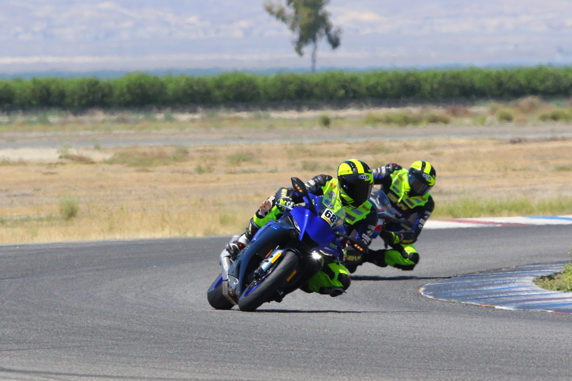 Hero image showing multiple motorcycles on a racetrack during a track day session