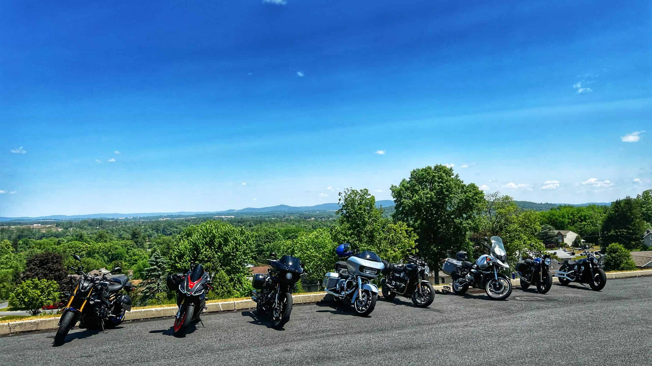 Riders checking in at a registration booth or staging area for a charity motorcycle event
