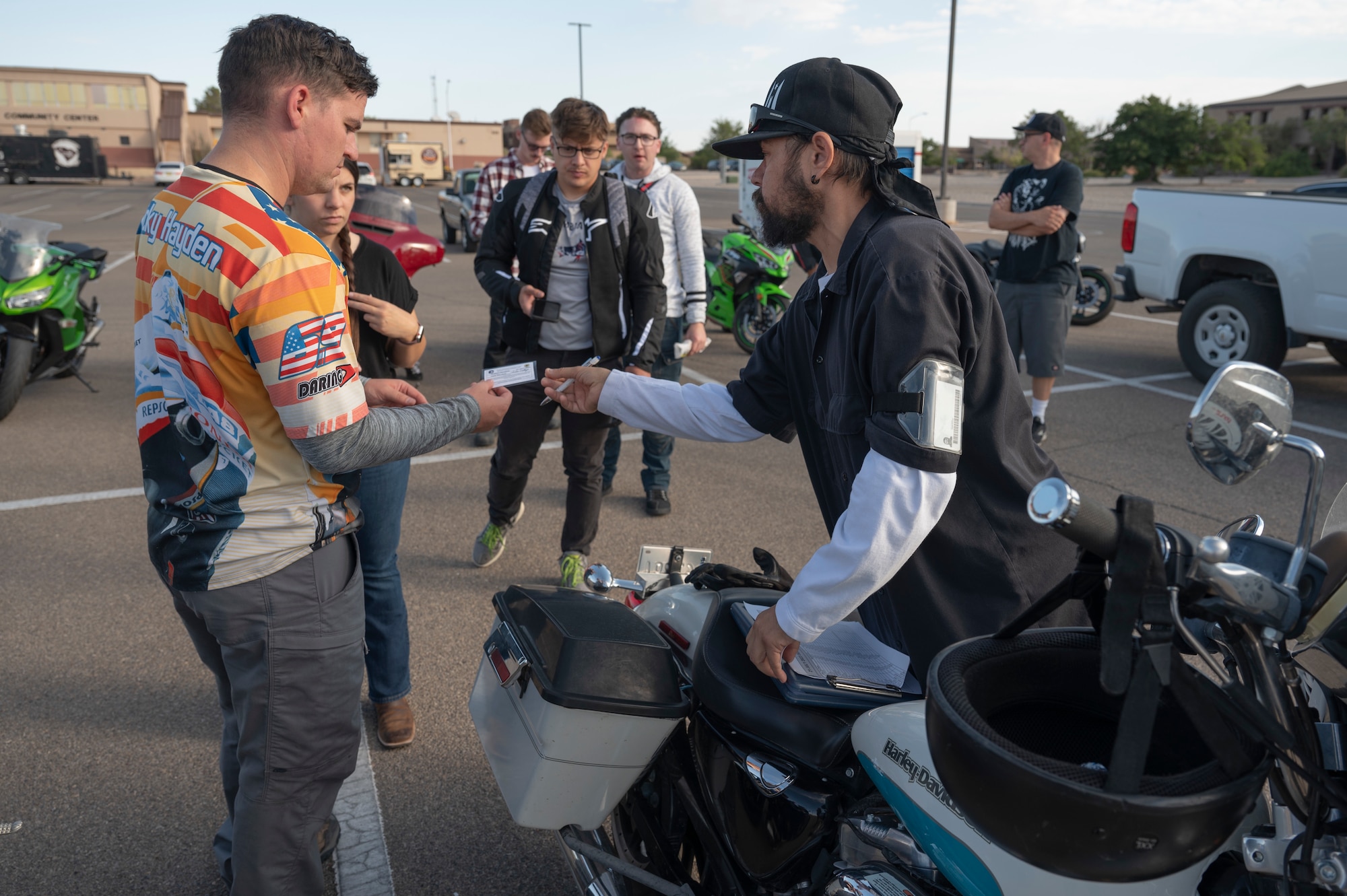 Group of riders gathered at a staging area for a club meetup