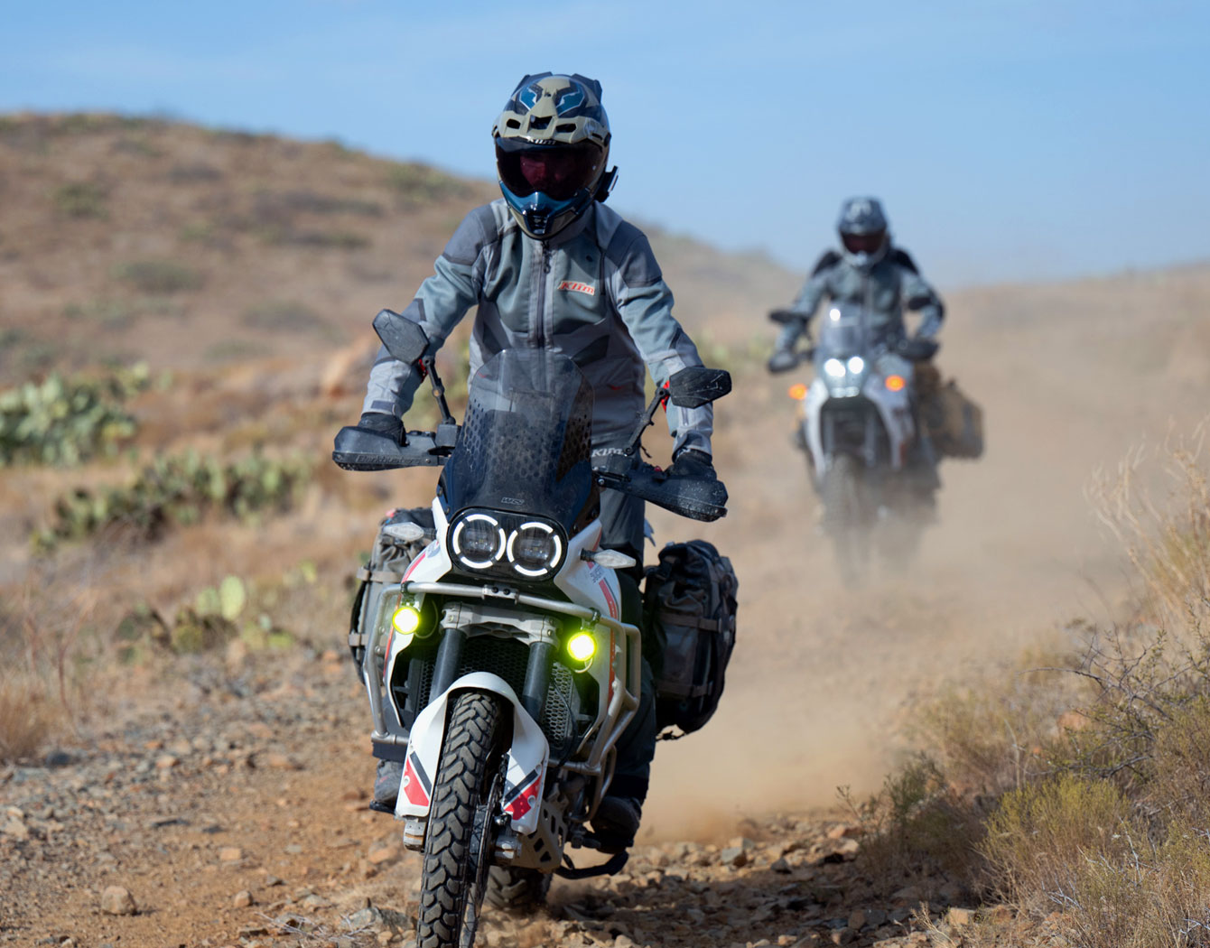 Action shot of riders testing intercoms on canyon roads