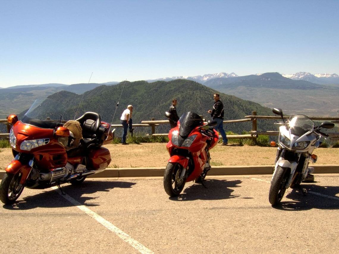 Rider on an ADV bike navigating gravel or mountain terrain during a comparison ride