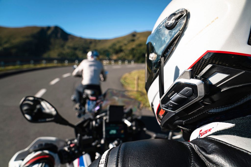 Hero image showing rider with intercom headset on open road