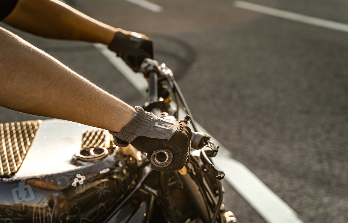Detail shot of motorcycle-specific gloves on a rider's hands