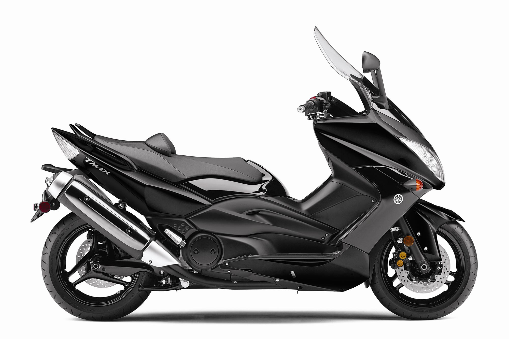 Rider aboard the TMAX on an open highway, showcasing touring capability